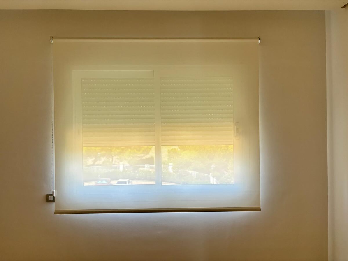 Image showing the professional installation of a curtain track and mechanism system by our team